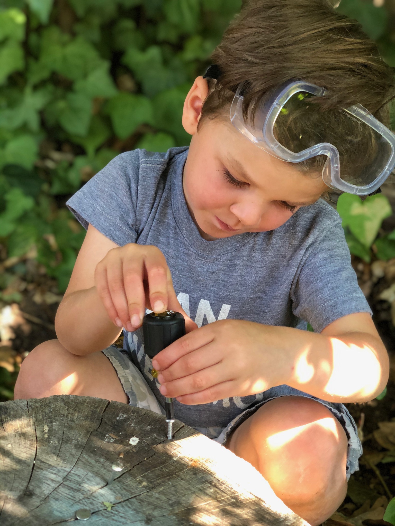 Child with safety goggles building outdoors at TRP