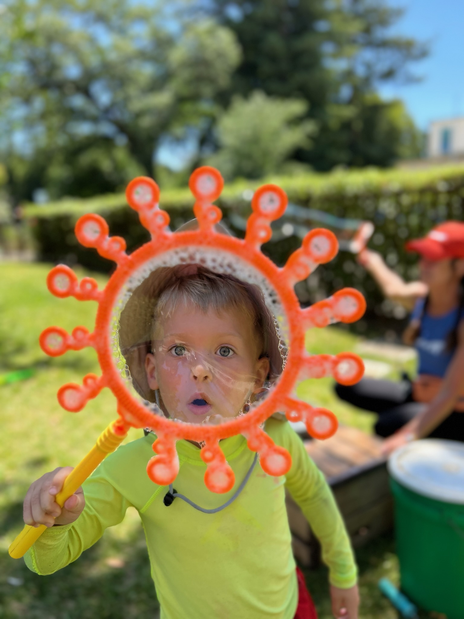 Child with giant bubble wand at TRP summer camp