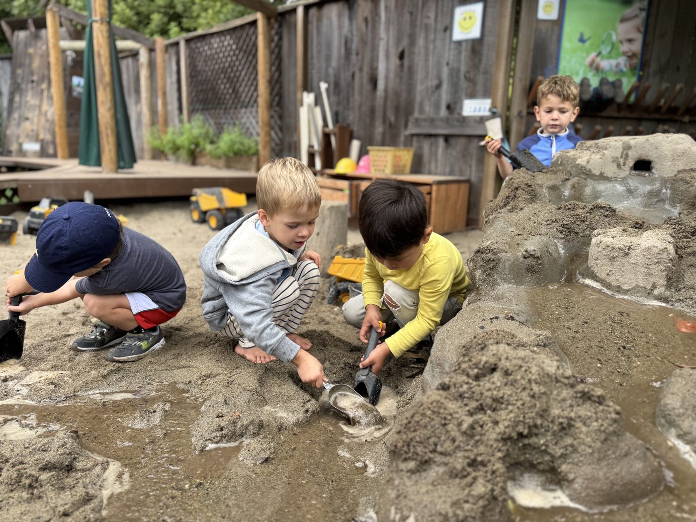 Boys digging and building in the sand pit at TRP