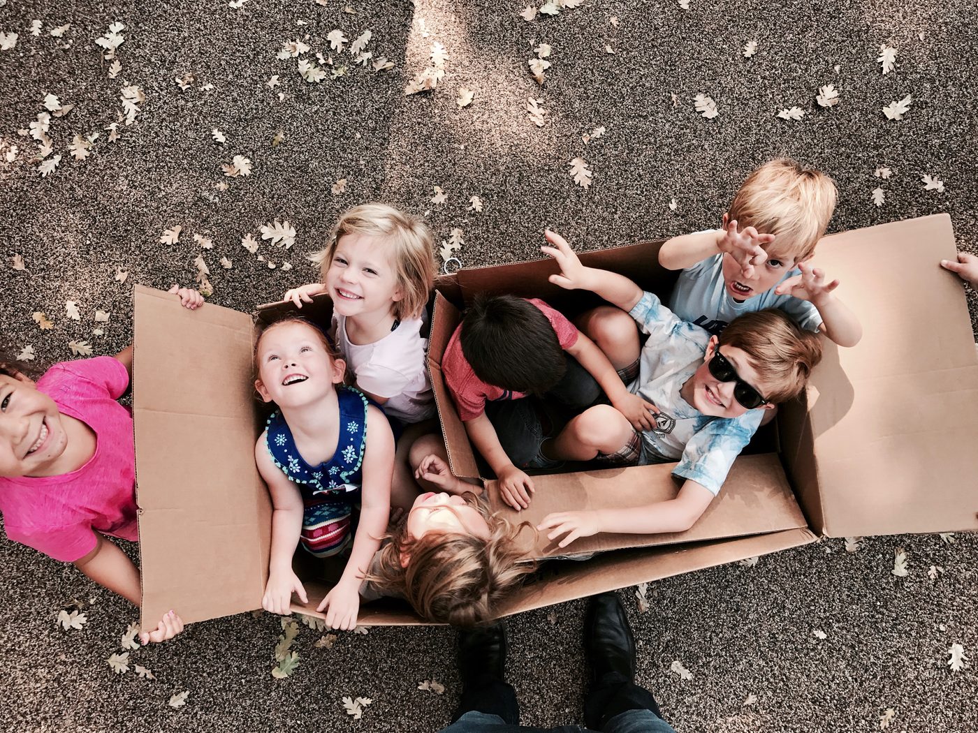 Children playing with cardboard boxes at The Ross Preschool